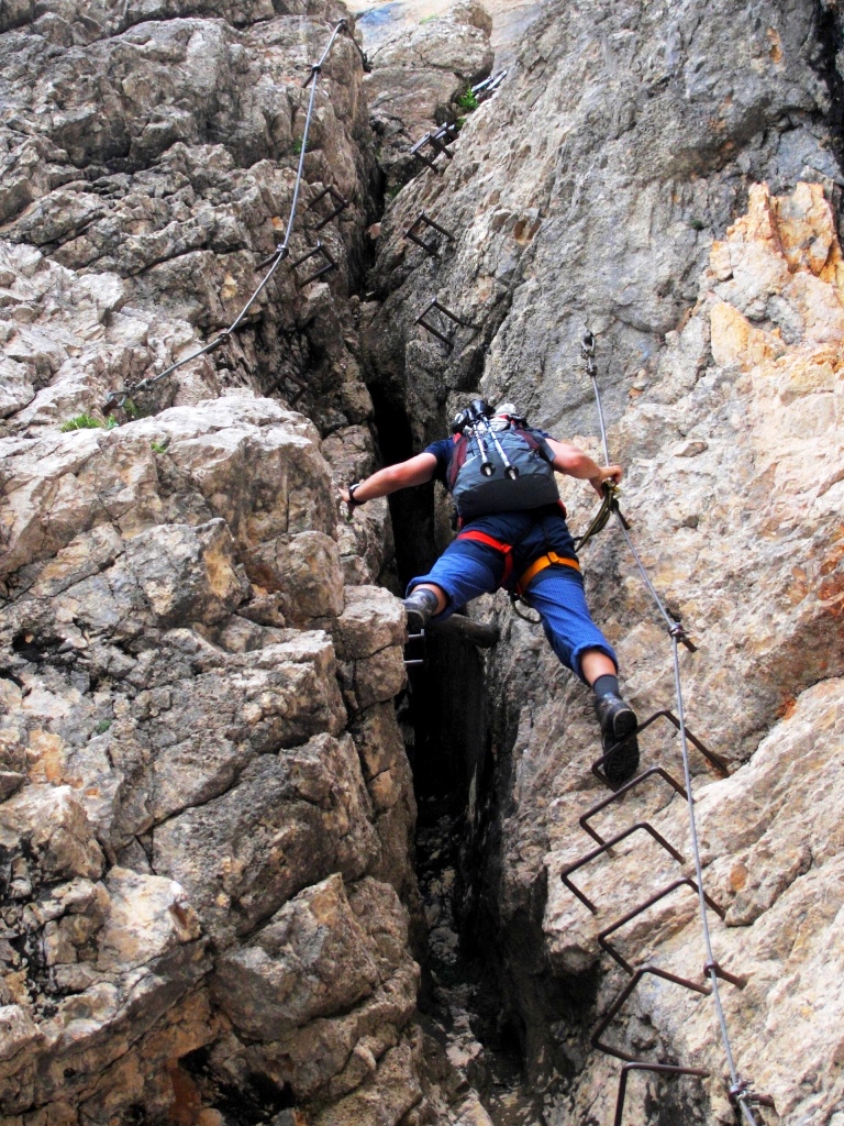 Climbing with the help of iron rungs.