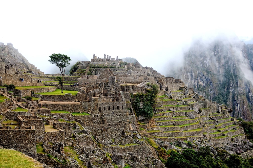 The labyrinth Machu Picchu at dawn, as the mist rises in the background. Image Credits: wikipedia.org