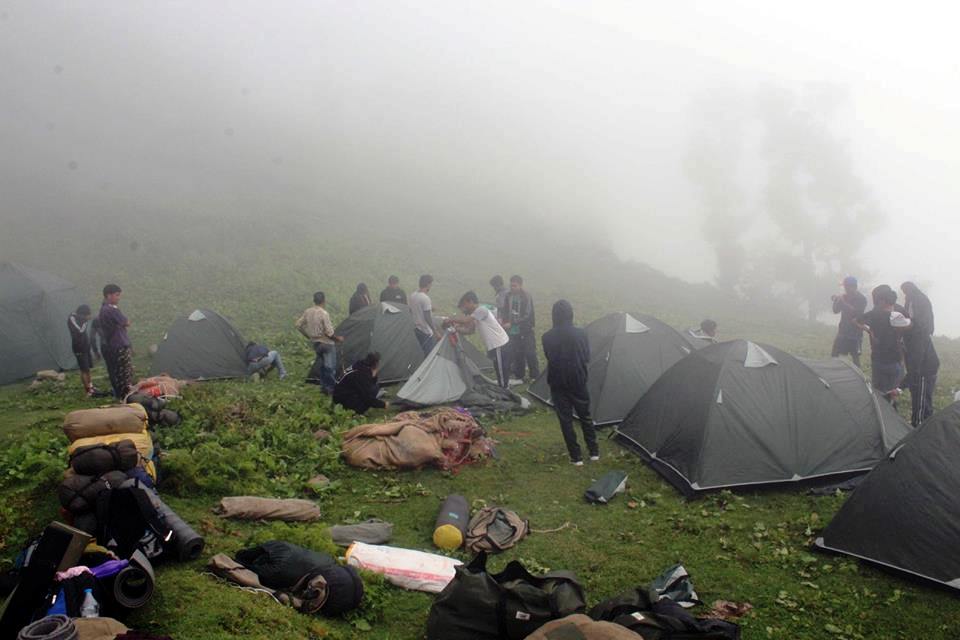 A group of students setting up camp during the Nag Tibba Trek